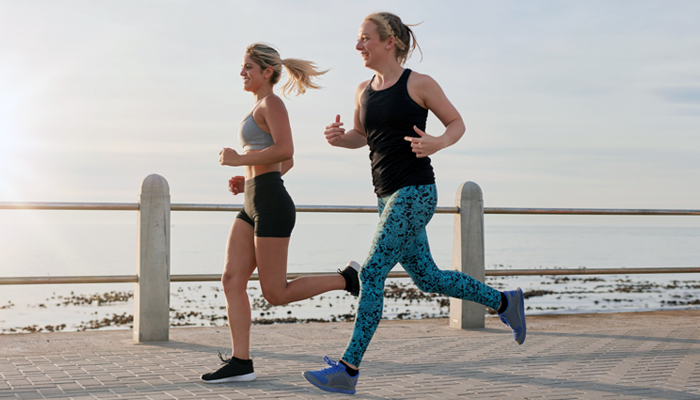 two women running on pier